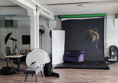 Photography studio at Flower City Studios with lights and backdrop.