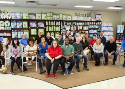 Group photo of the cast and crew sitting after a television commercial production